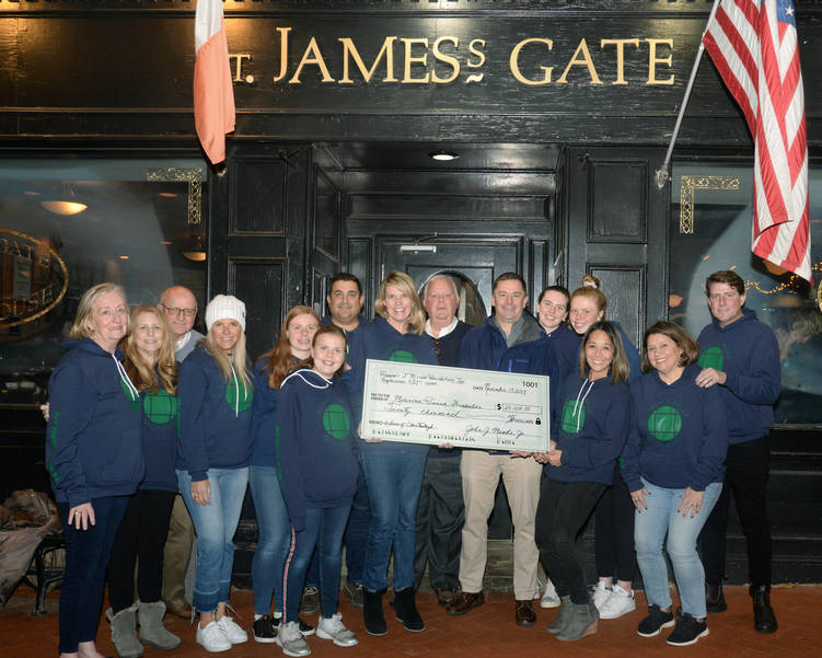 The Oysterfest volunteer team presents a check for $20,000 to the Melanoma Research Foundation
